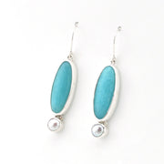 Handmade sterling silver dangle earrings with amazonite and pearl on white background