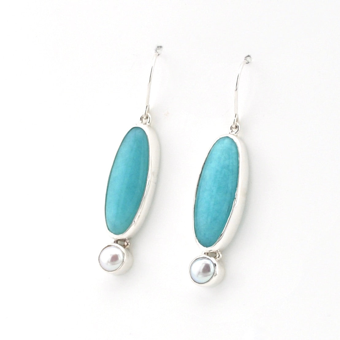 Handmade sterling silver dangle earrings with amazonite and pearl on white background
