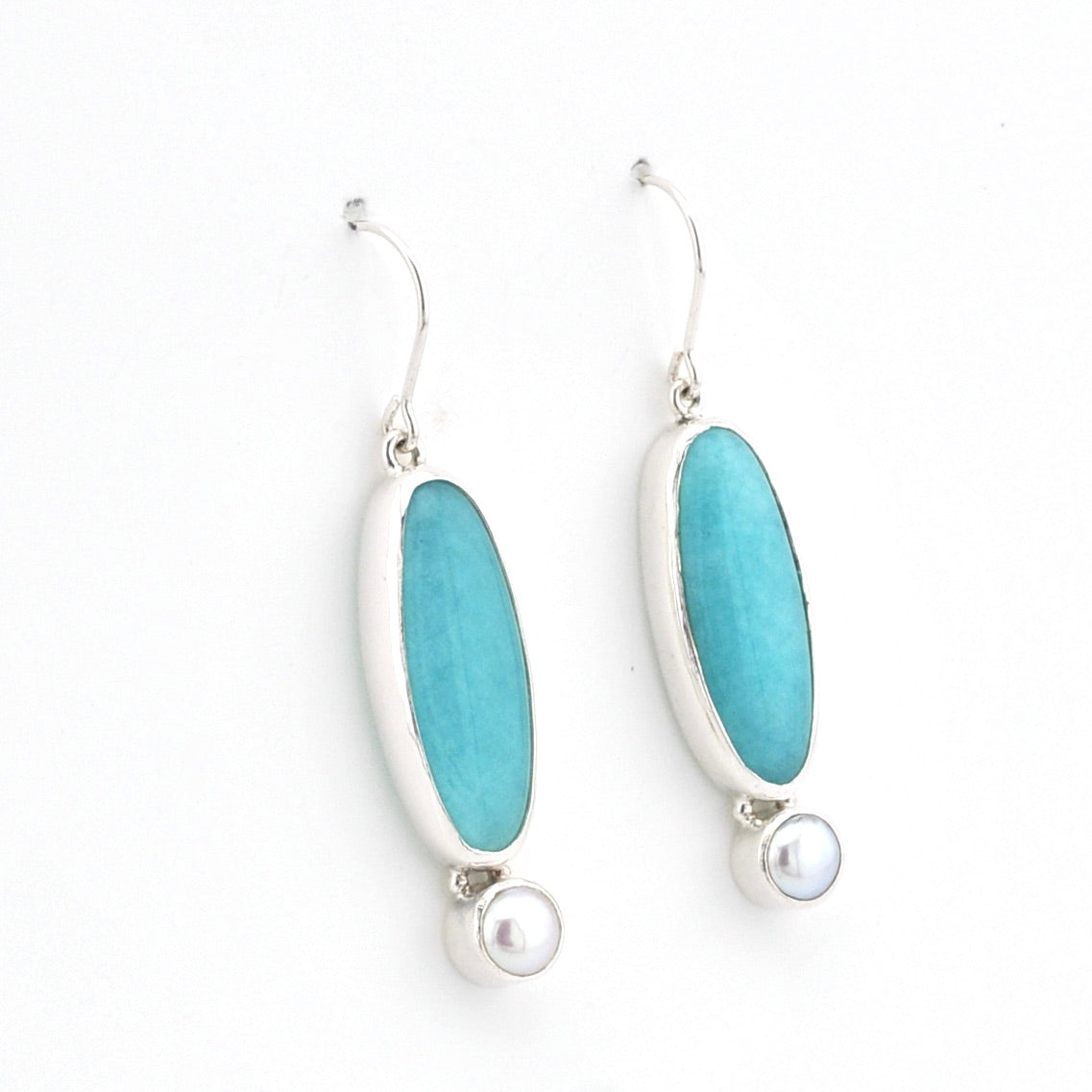 Handmade sterling silver dangle earrings with amazonite and pearl on white background