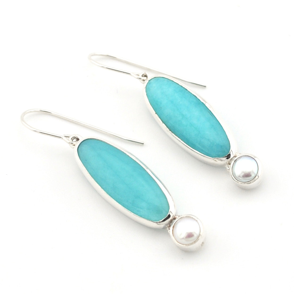 Handmade sterling silver dangle earrings with amazonite and pearl on white background