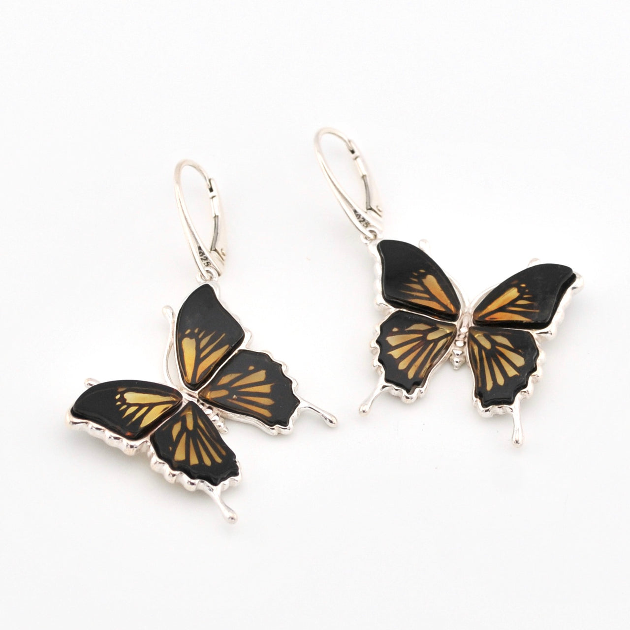 Butterfly-shaped earrings with black and gold design on a white background