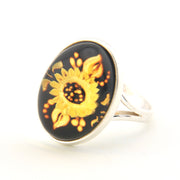 Ring with gold floral design on a black background