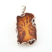 Brown pendant with silver frame on a white background
