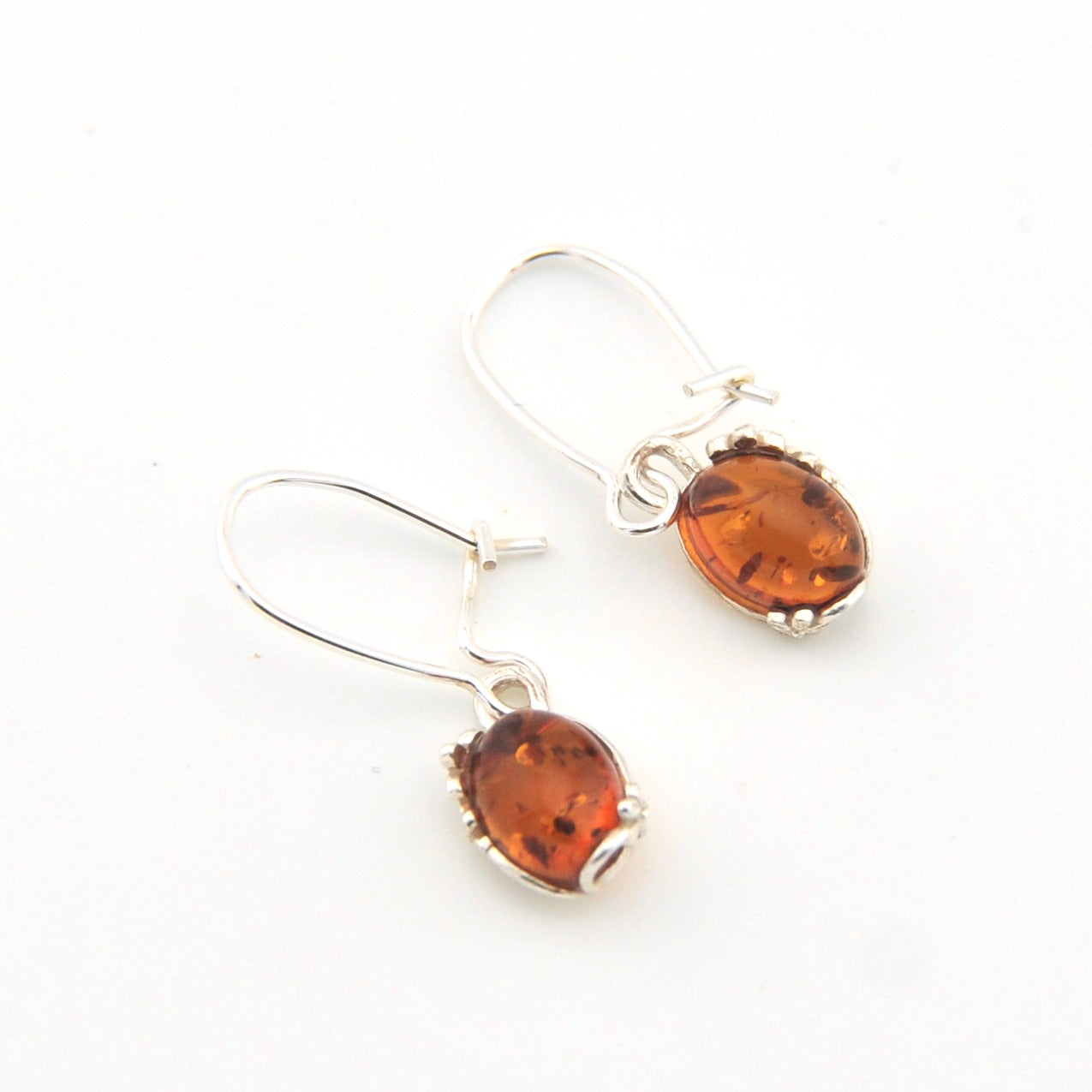 Pair of amber stone earrings on a white background