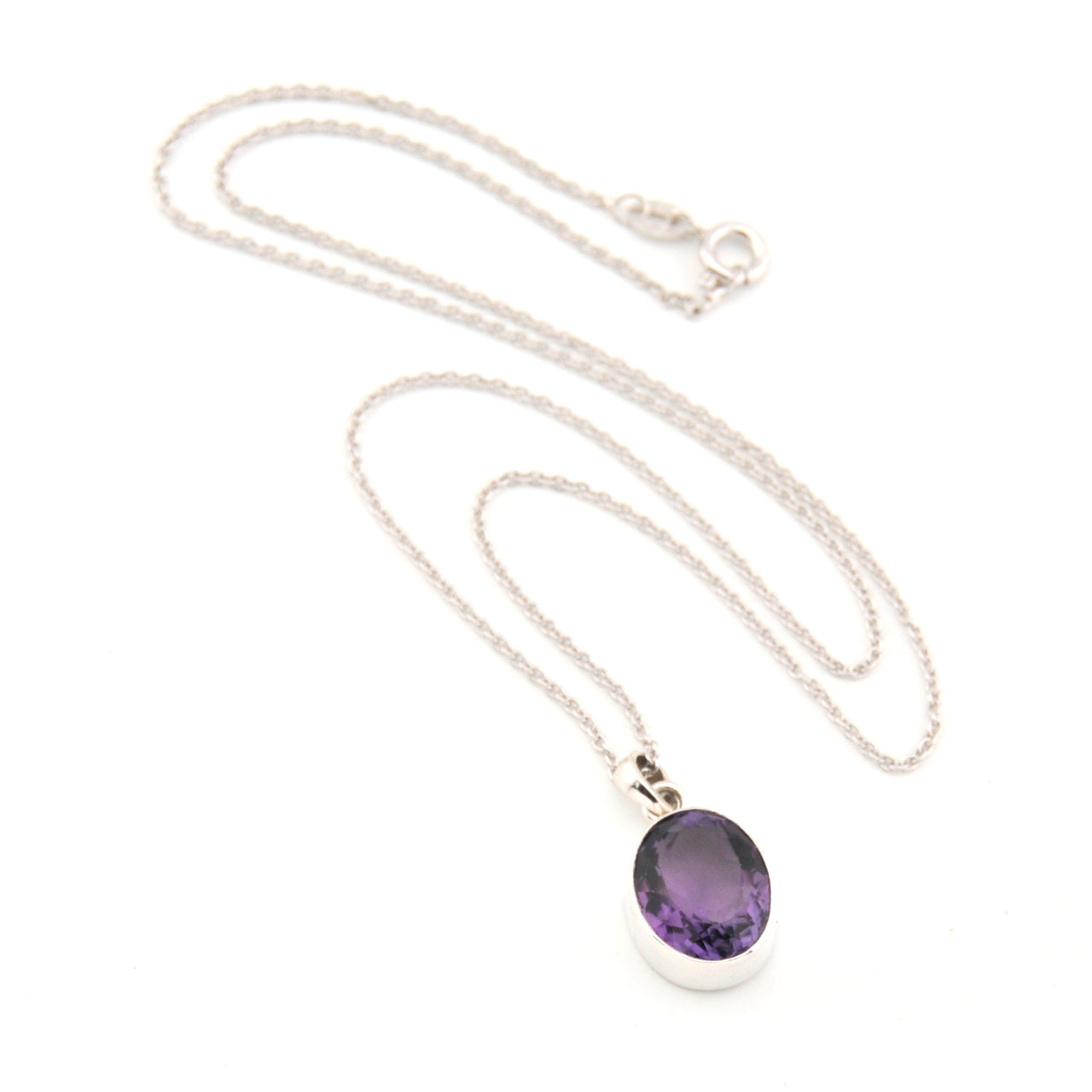 Silver necklace with a purple pendant on a white background