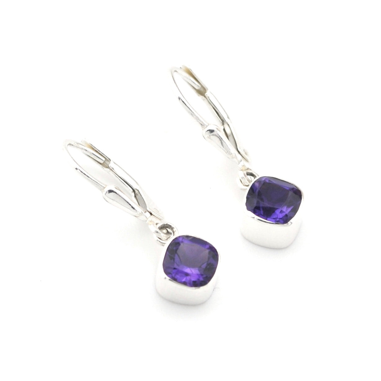 Silver earrings with purple gemstones on a white background