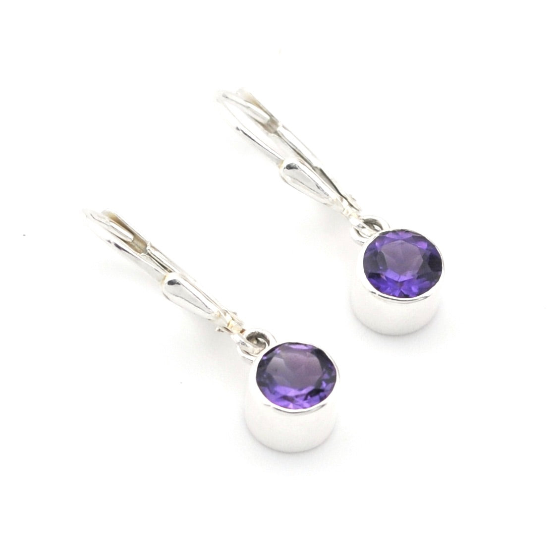 Pair of silver earrings with purple gemstones on a white background