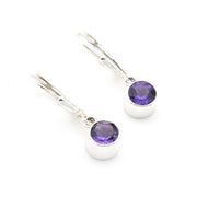 Pair of silver earrings with purple gemstones on a white background