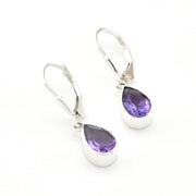 Silver earrings with purple teardrop-shaped gemstones on a white background