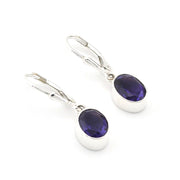 Silver earrings with purple gemstones on a white background