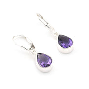 Pair of silver earrings with purple teardrop-shaped gemstones on a white background