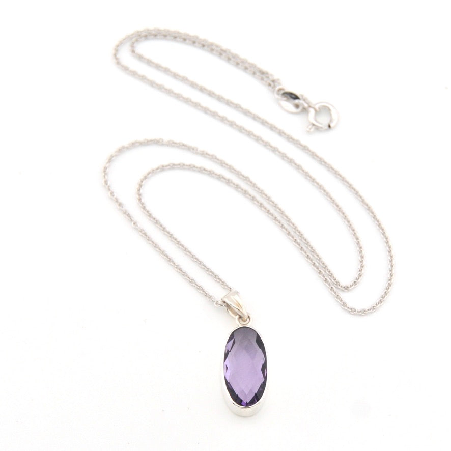 Necklace with a purple pendant on a white background