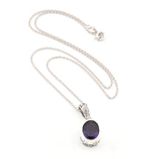Silver necklace with a purple gemstone pendant on a white background