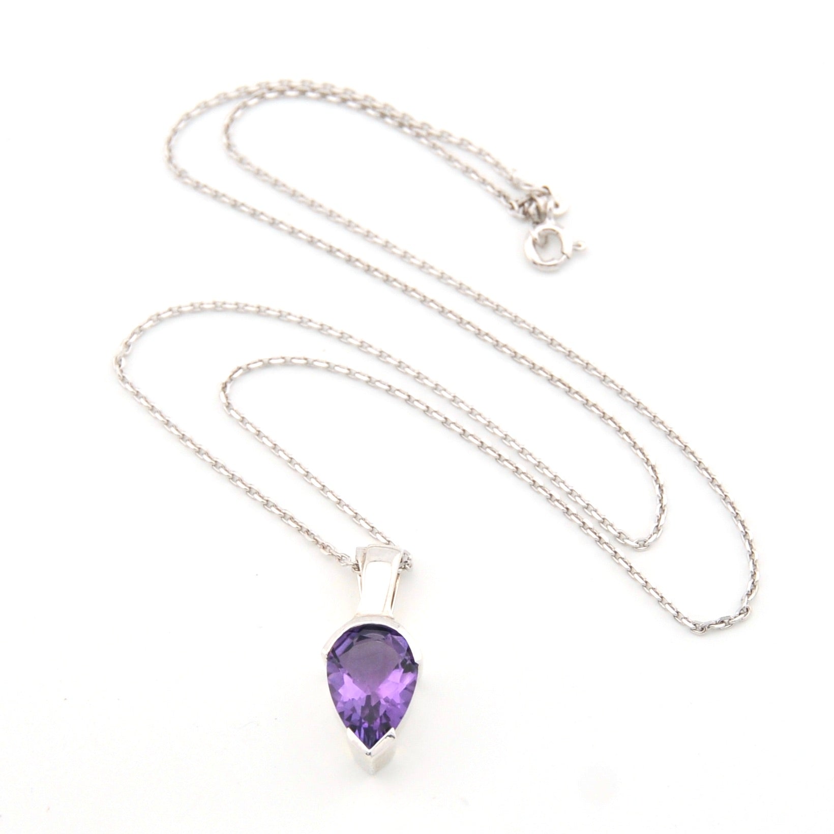 Necklace with a purple teardrop pendant on a white background