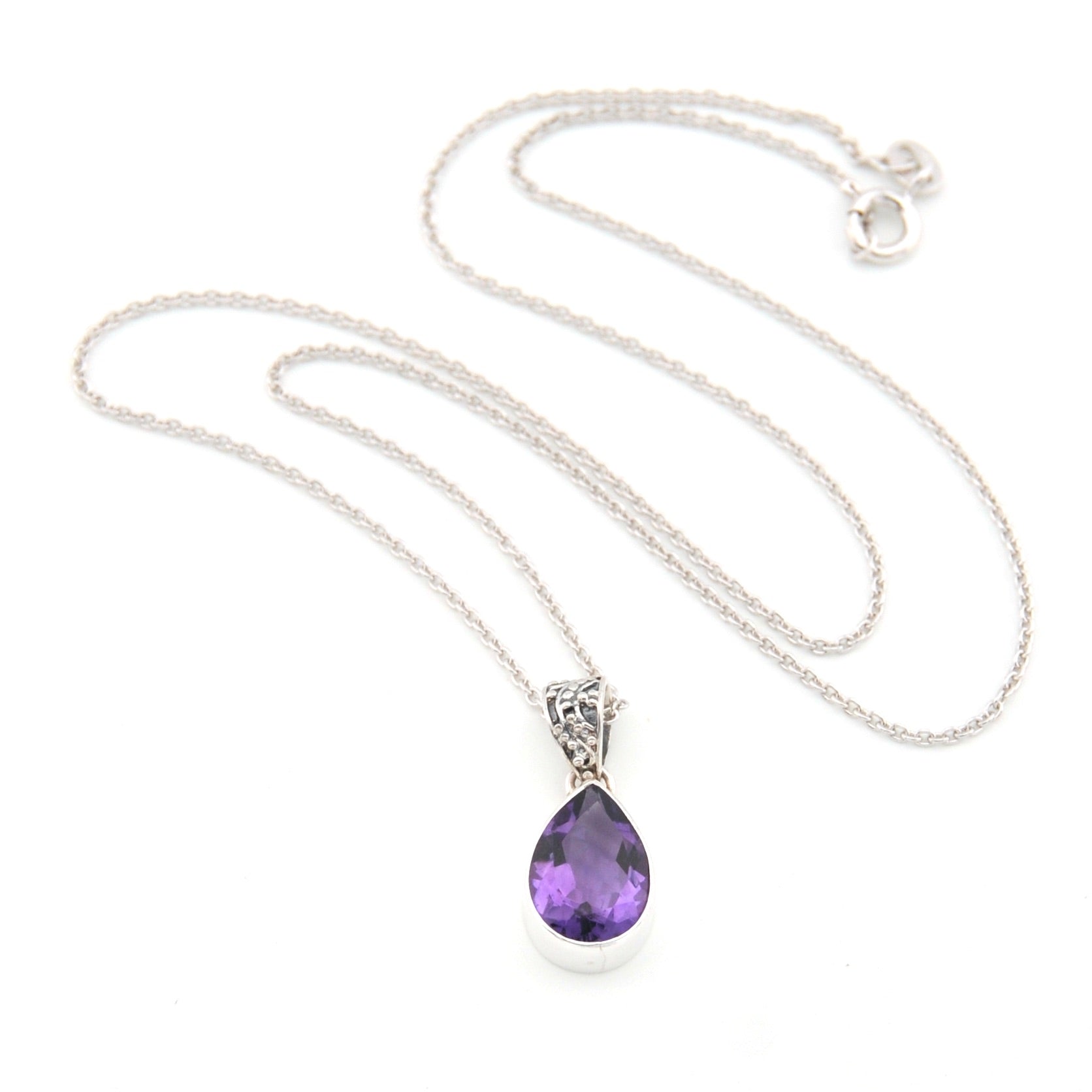 Necklace with a purple teardrop pendant on a white background