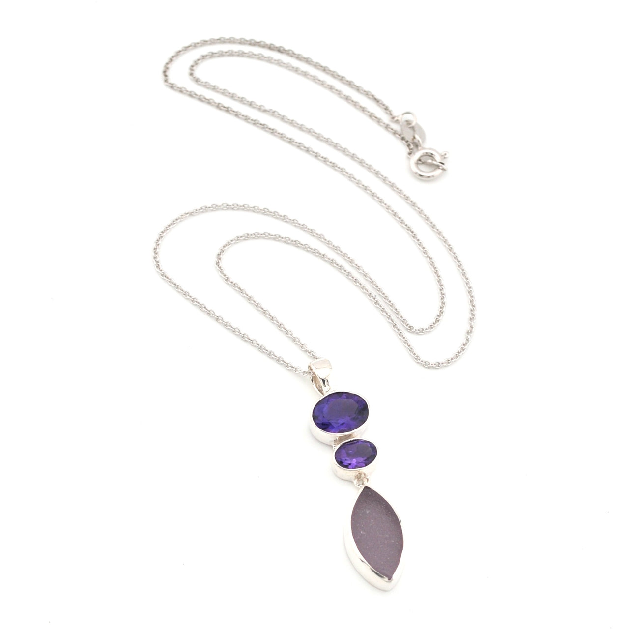 Necklace with amethyst and purple sea glass pendant on a white background