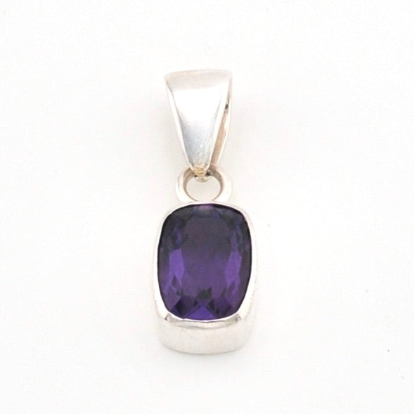 Silver pendant with a purple gemstone on a white background