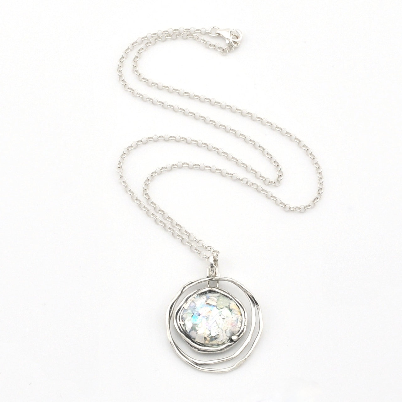 Silver necklace with a round pendant on a white background