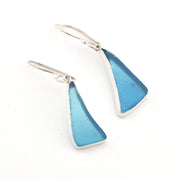 Pair of blue triangular earrings with silver hooks on a white background