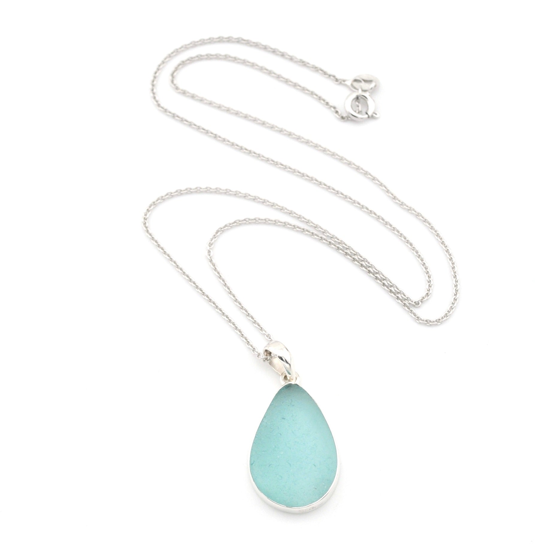 Teardrop-shaped light blue pendant on a silver chain against a white background