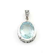 Silver pendant with a blue gemstone on a white background