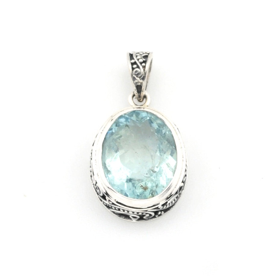 Silver pendant with a blue gemstone on a white background