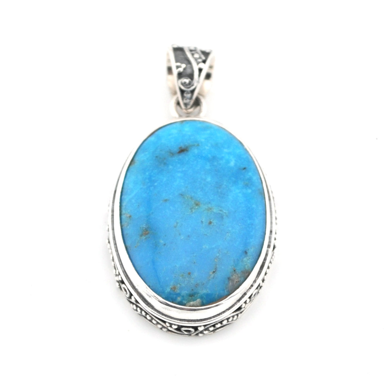 Turquoise pendant with silver setting on a white background