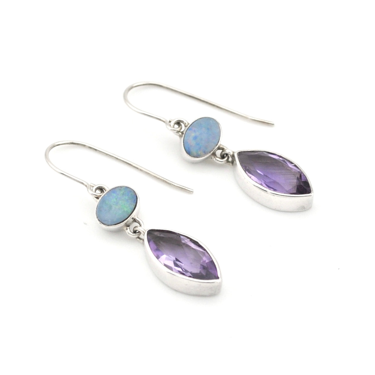 Pair of earrings with teardrop-shaped gemstones on a white background
