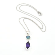 Necklace with a pendant featuring two gemstones on a white background