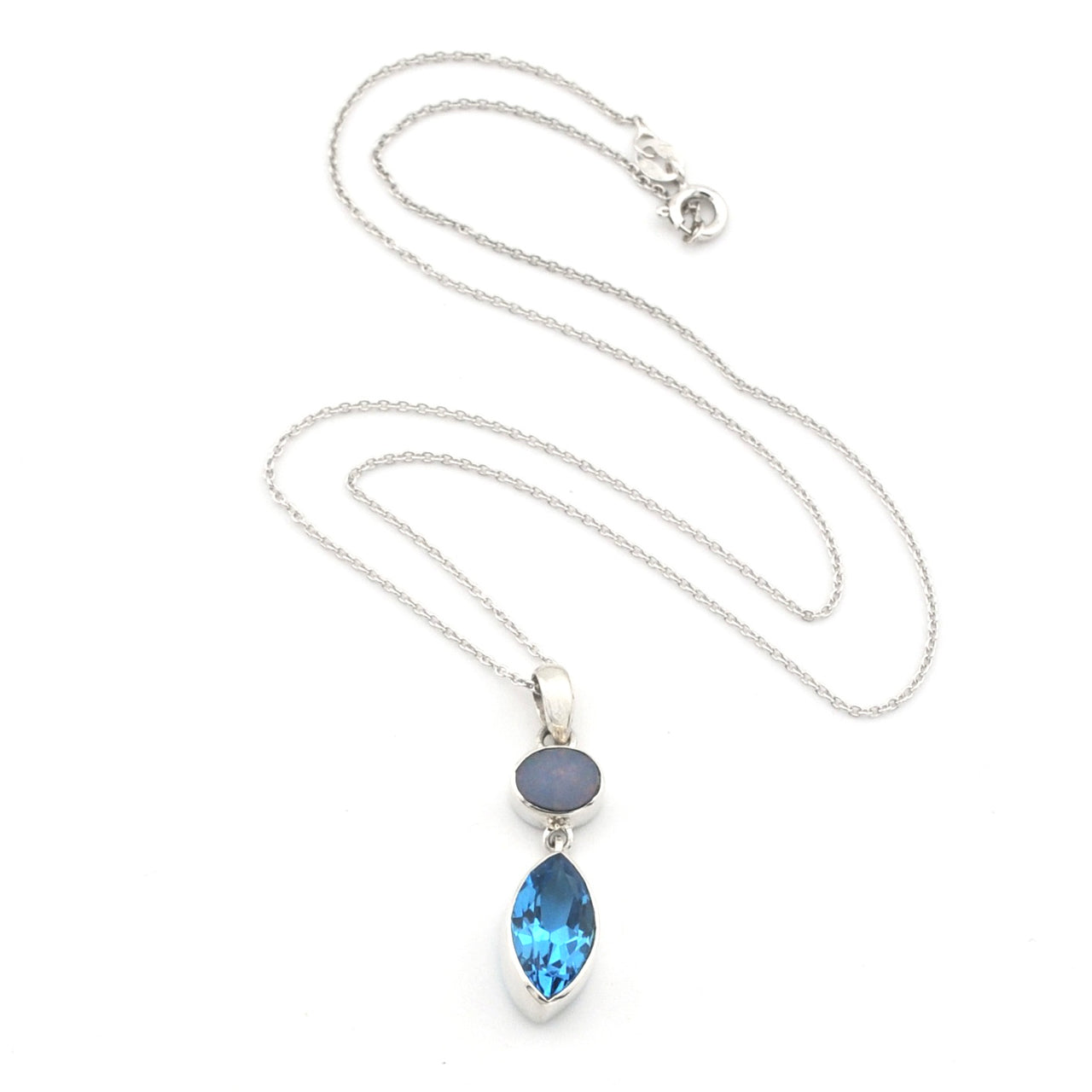 A silver necklace featuring a marquise-cut blue topaz pendant and a small oval opal stone, displayed on a clean white background.