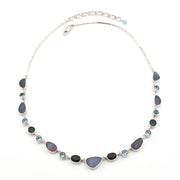 Necklace with opal, blue topaz, green quartz on a white background