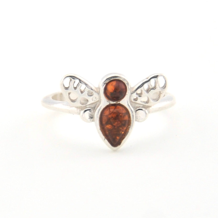 Silver ring with amber stones on a white background