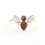 Silver ring with amber stones on a white background