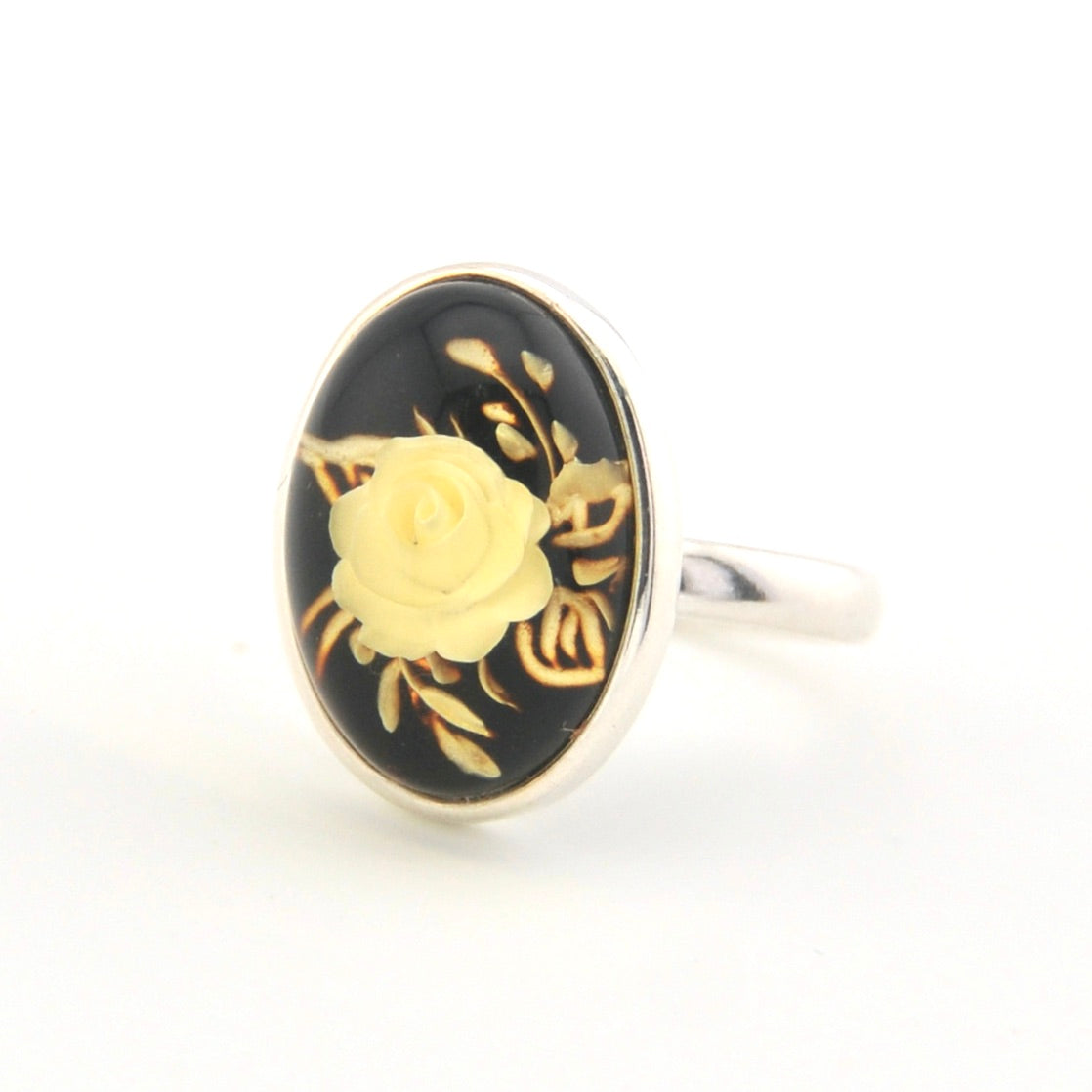 Ring with gold rose design on black background