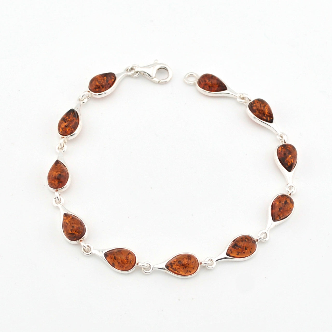 Silver bracelet with amber on a white background