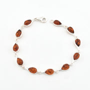 Silver bracelet with amber on a white background