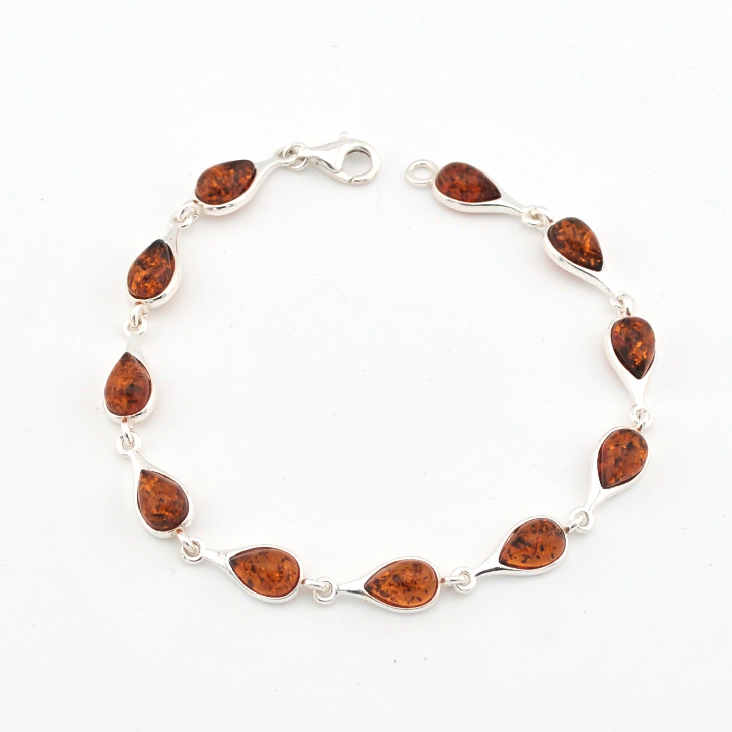 Silver bracelet with amber on a white background