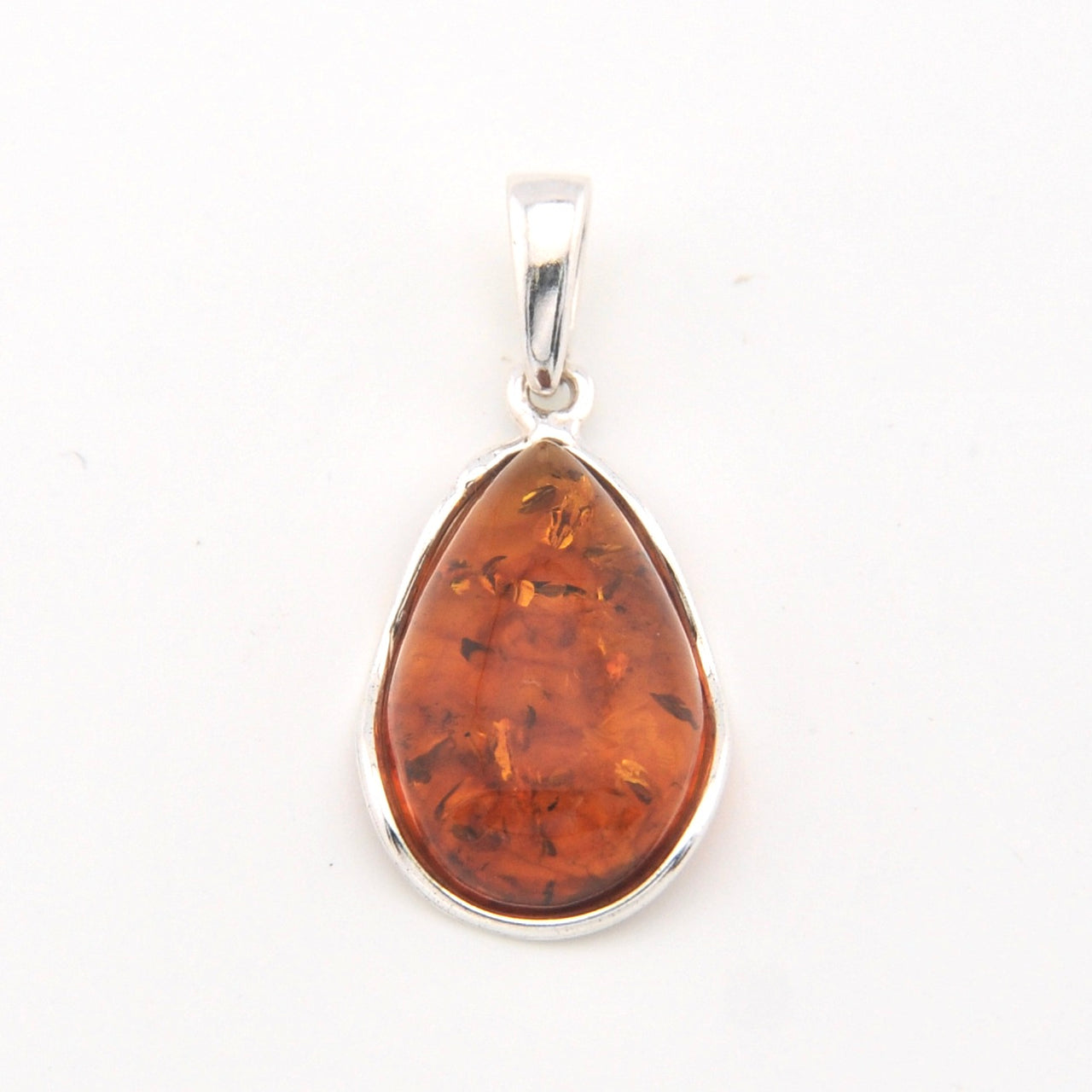 Teardrop-shaped amber pendant on a silver chain against a white background