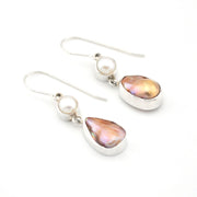 Pair of earrings with teardrop-shaped pearls on a white background