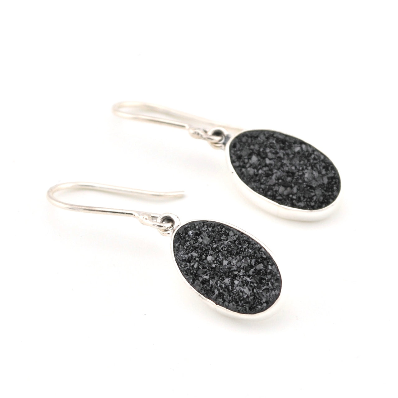 Black stone earrings with silver hooks on a white background