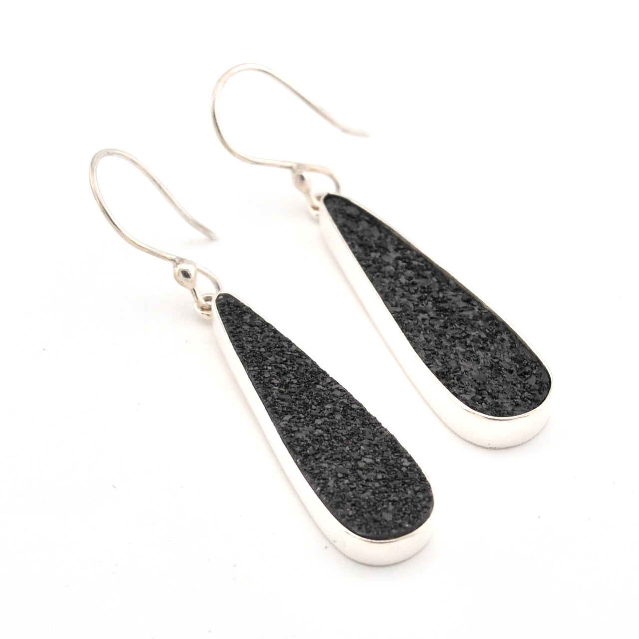 Black teardrop earrings with silver hooks on a white background