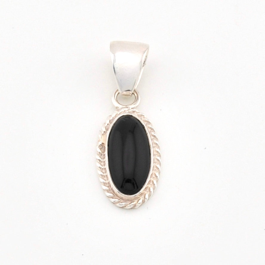Silver pendant with a black stone on a white background