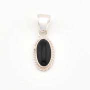 Silver pendant with a black stone on a white background