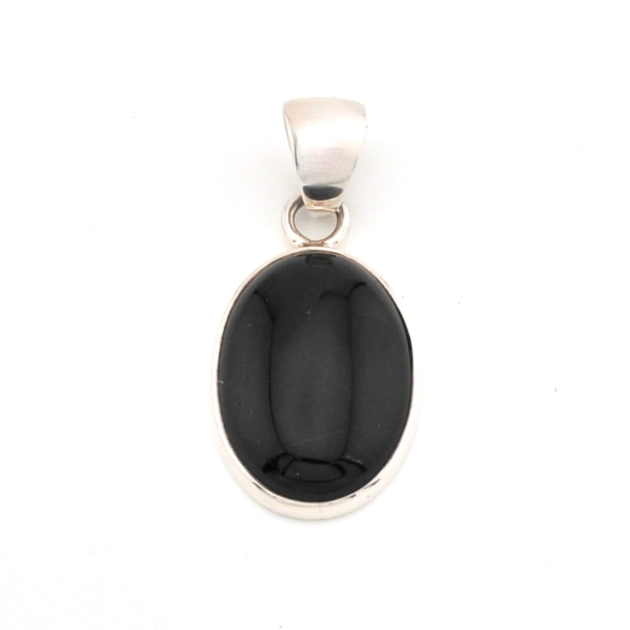Black stone pendant with silver setting on a white background