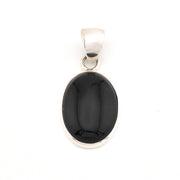 Black stone pendant with silver setting on a white background