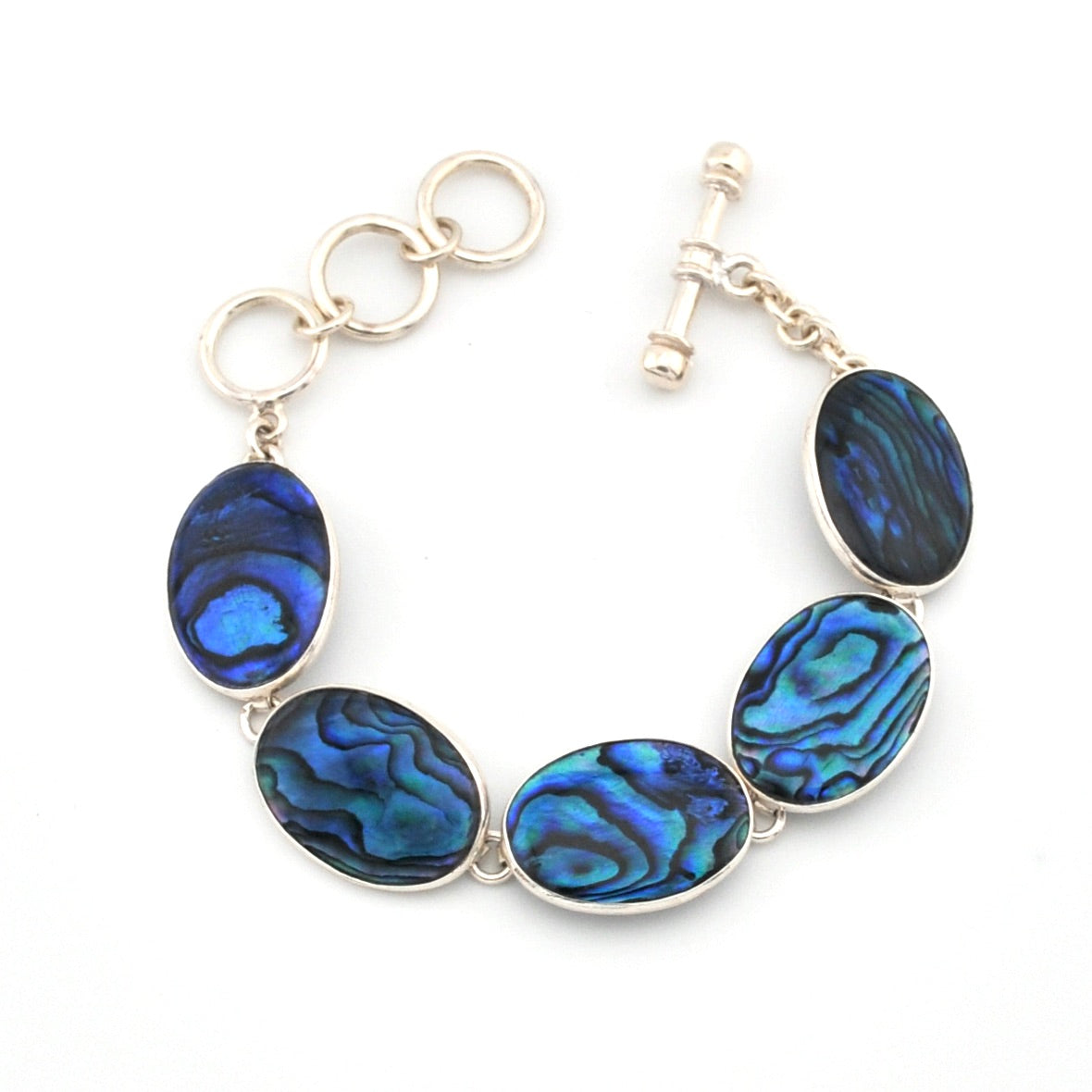 Silver bracelet with blue abalone shell on a white background