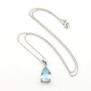 Necklace with a teardrop-shaped blue gemstone pendant on a white background