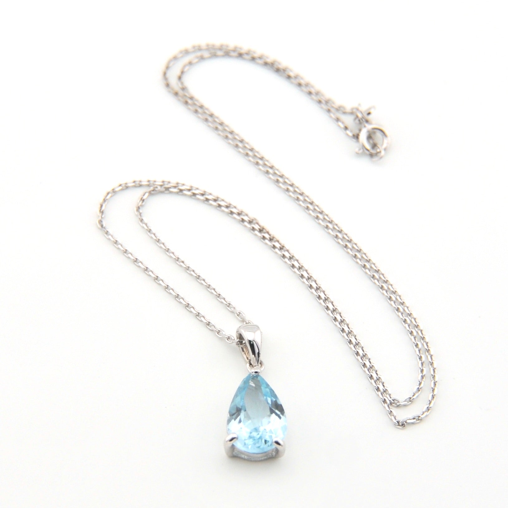 Necklace with a teardrop-shaped blue gemstone pendant on a white background