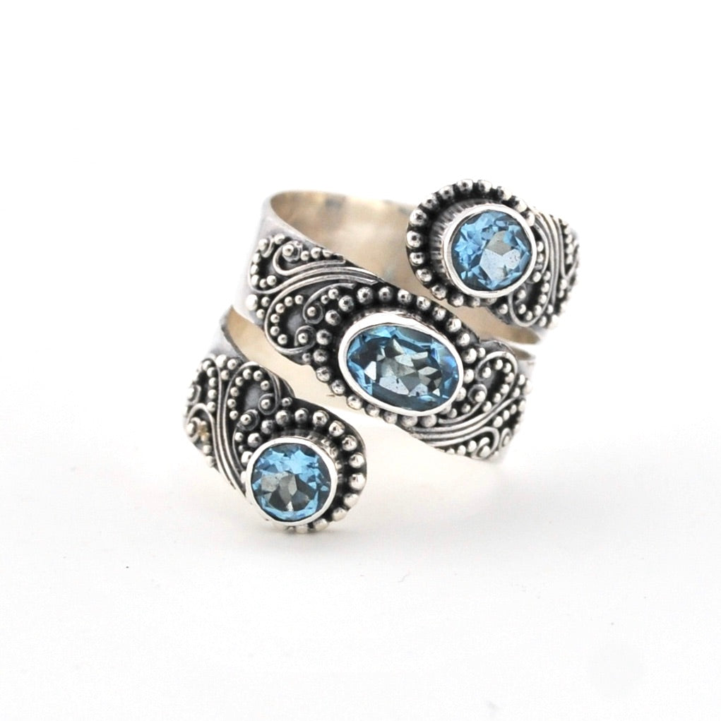 Silver ring with blue gemstones on a white background