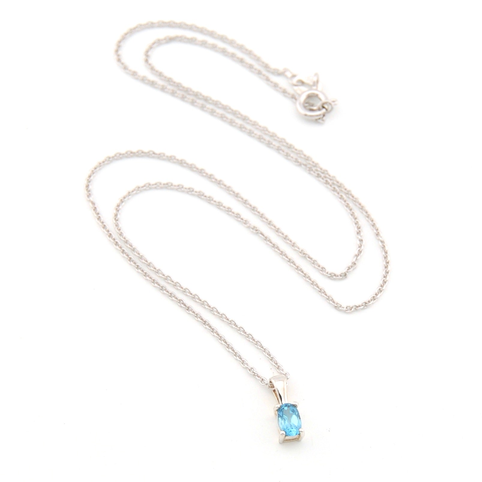 Necklace with a blue gemstone pendant on a white background